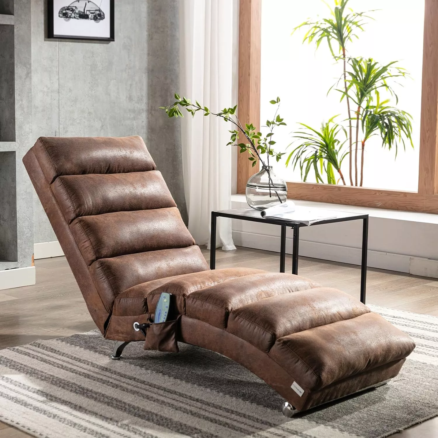 Modern ergonomic chaise lounge in distressed brown faux leather, featuring segmented cushioning, a built-in side pocket, and set on a striped area rug near a minimalist glass-top side table with a plant vase in a bright living room.